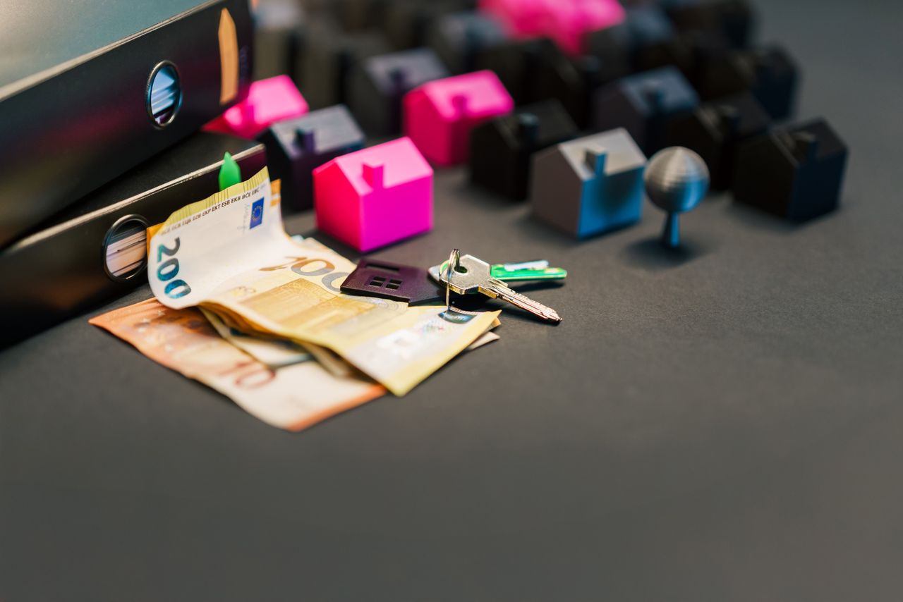 services-03 Miniature houses, euro bills, and a house key symbolize real estate investment and property transactions.